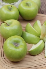 green apples is delicious on wood background.
