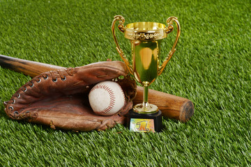 closeup baseball trophy with bat ball and glove