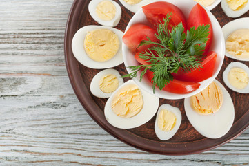 Boiled hen eggs and red tomato