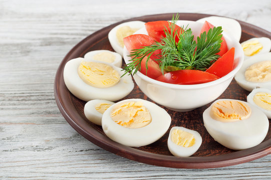 Boiled hen eggs and red tomato