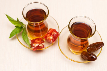  Arabic nana mint tea in traditional glasses and dates