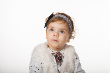 little girl in elegant clothes on a white background in studio