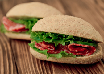 Fresh wholegrain sandwiches with salami and lettuce