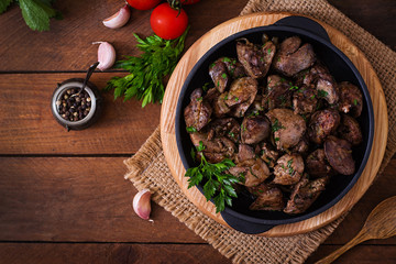 Fried chicken liver with onions and herbs. Top view