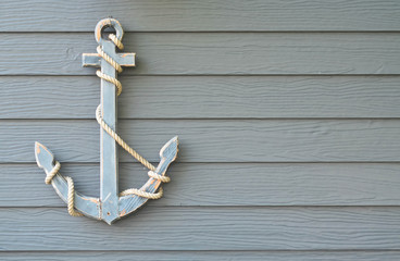 Wooden nautical anchor on wood wall