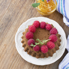 Simple homemade chocolate cake with fresh ripe raspberries