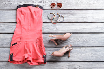 Jumpsuit shorts and heel shoes. Salmon jumpsuit shorts. Woman's stylish apparel in stock....
