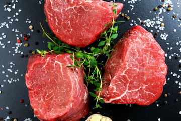 Fresh Raw Beef steak Mignon, with salt, peppercorns, thyme, garlic.