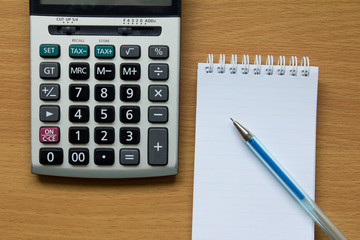 Calculator, notebook and pen