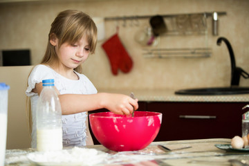 Girl 7 years preparing breakfast in the kitchen.