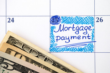 Reminder Mortgage Payment in calendar with dollar banknotes