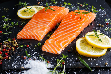 fresh raw salmon fillet with aromatic herbs, spices.