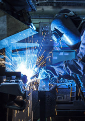 Industrial steel worker speeds motion in factory