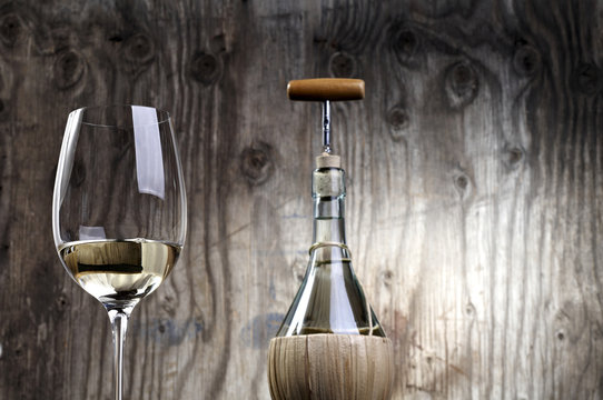 White wine on table on wooden background