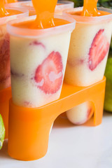 Homemade ice cream with pineapple,strawberry and lime