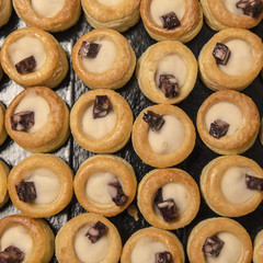 Many small catering tarts on a black background