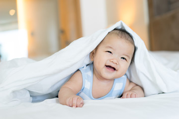 Portrait of a newborn Asian baby on the bed - 111947475