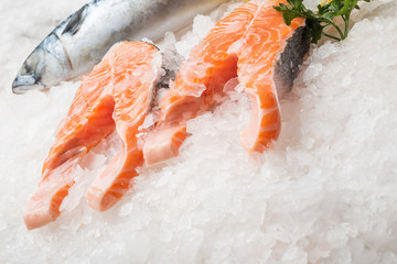 Fresh salmon fish on ice at market