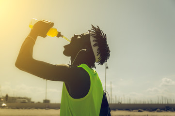 Sportive man drinking outdoor 