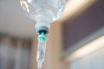 Infusion bottle with IV solution in hospital