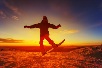 Snowboarder on the mountain with a sunset