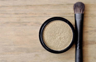 Eyeshadows in black box on wood table