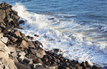 The waves of the Pacific ocean, the beach landscape. The ocean and waves during strong winds in United States, Santa Monica. Waves breaking on the rocks.