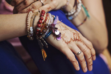 Female hands with mehndi and lot of bracelets