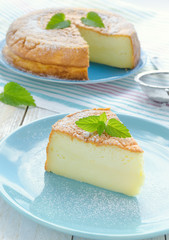 Japanese cheesecake decorated with mint, icing sugar and strawberry
