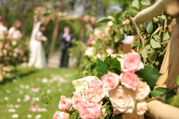 Pink roses on a background of the bride and groom.