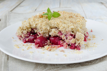 Cherry crumble pie on white plate