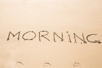 Abstract hand writing on the sand word Morning