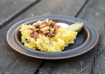 Estonian national dish. Potatoes with bacon and pickled cucumber.