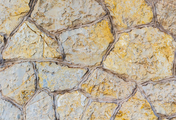 Old stone wall. Stonework of sandstone. Golden and grey texture. Can be used as background