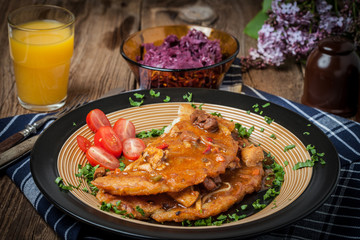Potato pancakes with meat stew served on a plate.