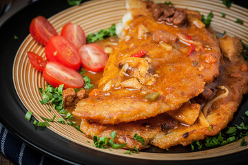 Potato pancakes with meat stew served on a plate.