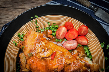 Potato pancakes with meat stew served on a plate.