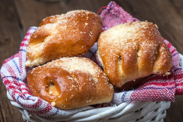 Buns with berries on a wooden table.