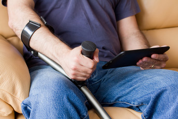 man with crutches holding tablet
