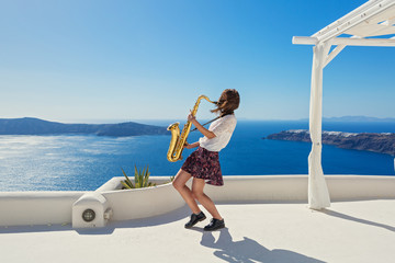 Girl,  saxophone and  sea