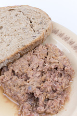 Canned tuna with bread served on a plate