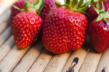 Berries juicy strawberries on a wooden background