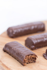 Chocolate bars on the wooden board, closeup macro