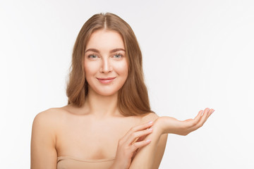 Obraz premium Portrait of happy smiling beautiful shirtless lady holding hand up in front of her over white background in studio. Studio shot. Beauty concept.