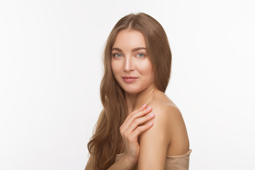 Fototapeta premium Beauty concept. Beautiful model lady in dress touching her shoulders over white background in studio. Studio shot.