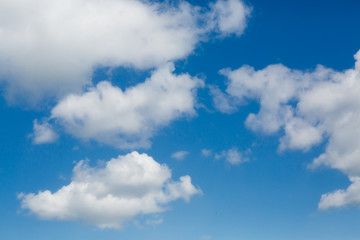 Fototapeta na wymiar Big clouds in the blue sky. Good cloudy weather. The sky above us. Background and texture of the cloudy sky.