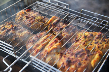 chicken breast grilled on a coals