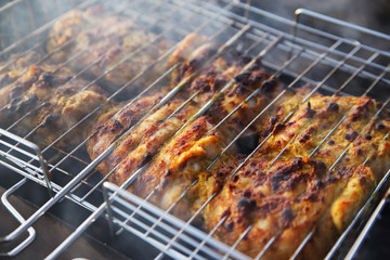 chicken breast grilled on a coals