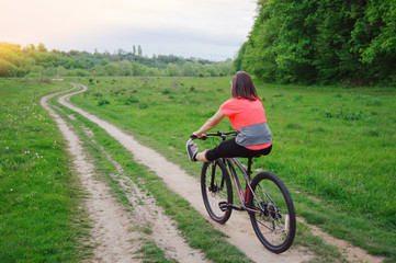 Fototapeta na wymiar A girl riding a bike