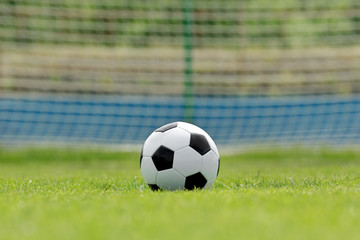 Soccer ball on football green field with space for text